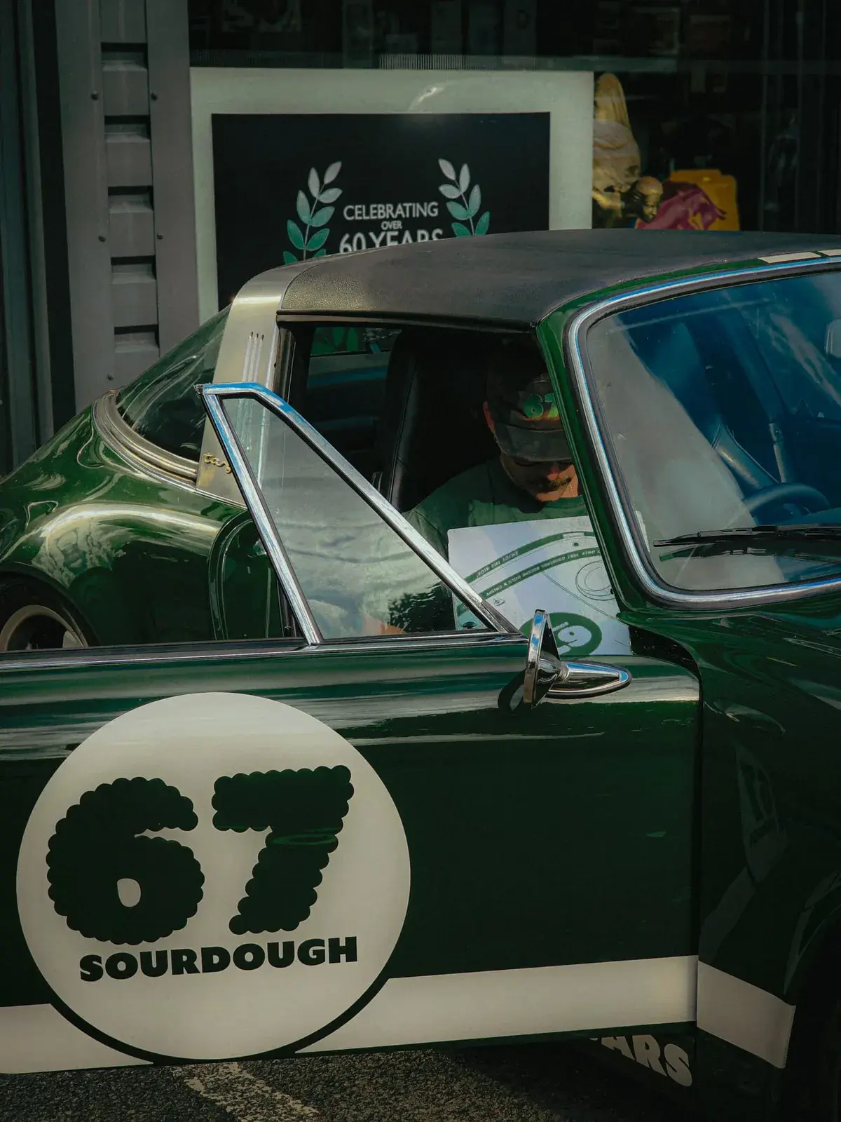 A green classic Porsche carrying the 67 Sourdough logo